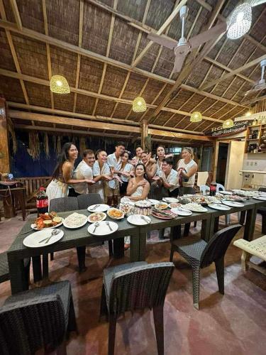 a group of people standing around a large table at RGL Place Siargao in General Luna