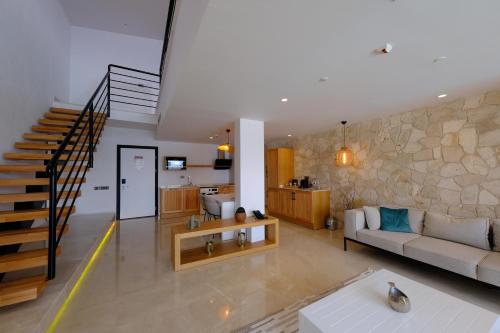 a living room with a couch and a staircase at Lures Hotel in Kalkan
