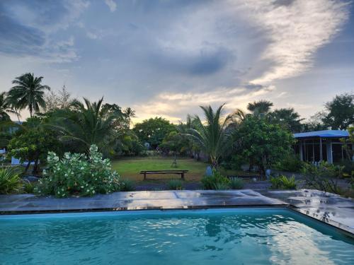 a swimming pool in a yard with a park at Kawinlodge khanom in Ban Thung O