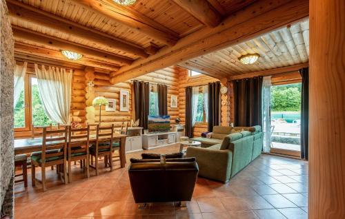 a living room with a table and a dining room at Cozy Home In Prokike With Sauna in Prokike