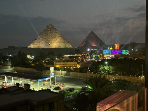 a view of the pyramids of giza at night at Unique Pyramids Boutique INN in Cairo