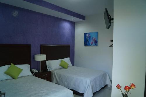 Una cama o camas en una habitación de Hotel Casa Palomino