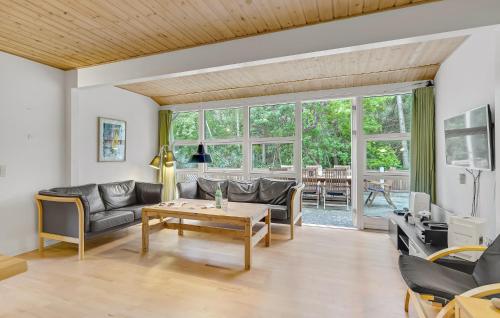 a living room with a couch and a table at Holiday Home Tjørnevænget Humble Ix in Humble