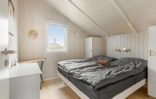 a bedroom with a bed in a room with a window at 2 Bedroom Lovely Home In Otterup in Otterup