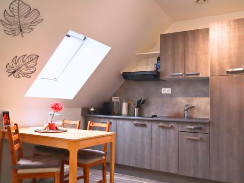 a kitchen with a table and a sink and a window at Studio en plein centre de Saint-Omer - à 5 min de la gare, parking gratuit in Saint-Omer