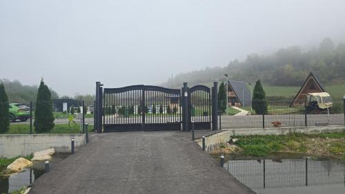 a gate in a driveway with a house in the background at Etno Selo RELAX in Šipovo