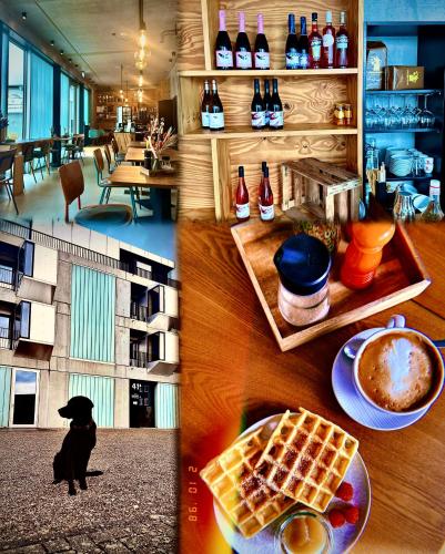 a table with waffles and a black dog in a restaurant at elferrooms Hotel in Ubstadt-Weiher