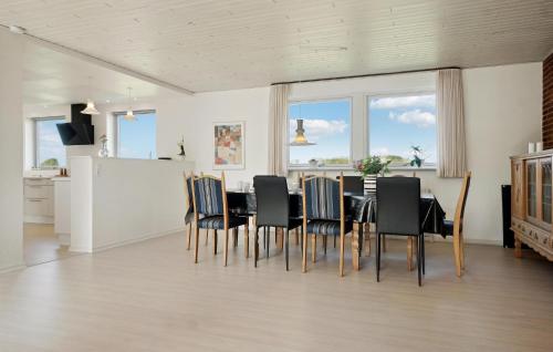 a kitchen and dining room with a table and chairs at Beautiful Home In Nykøbing M With Wifi in Nykøbing Mors