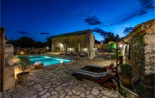 a house with a swimming pool at night at Gorgeous Home In Zelengrad With Kitchen in Zelengrad