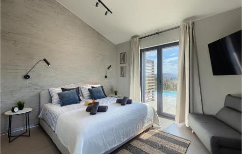 a bedroom with a large bed and a large window at Villa Noeli in Hum