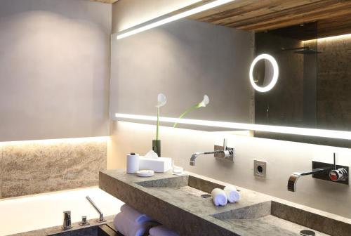 a bathroom with a sink and a mirror at SEVERIN*S – The Alpine Retreat in Lech am Arlberg