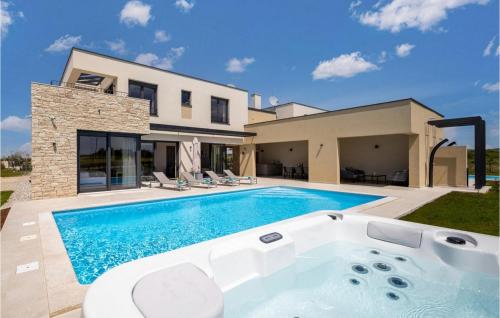 a swimming pool in front of a house at Villa Primavera in Brtonigla