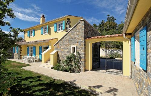 a yellow house with a gate in front of it at 6 Bedroom Cozy Home In Pazin in Brajkovići