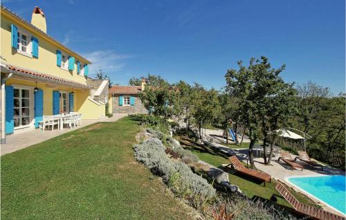a house with a swimming pool next to a yard at 6 Bedroom Cozy Home In Pazin in Brajkovići