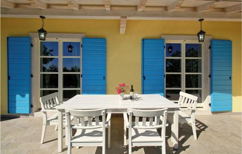 a white table and chairs on a patio at 6 Bedroom Cozy Home In Pazin in Brajkovići