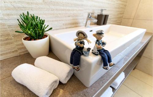 two figurines sitting on a sink in a bathroom at Villa Histria in Pula