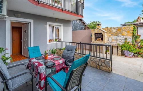 a table and chairs on a balcony with a fireplace at Awesome Apartment In Premantura in Premantura