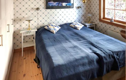 a blue bed with two pillows in a bedroom at 2 Bedroom Stunning Home In Värnamo in Värnamo