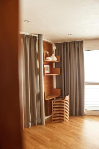 a living room with a book shelf and a window at Turm Chalet in Laces