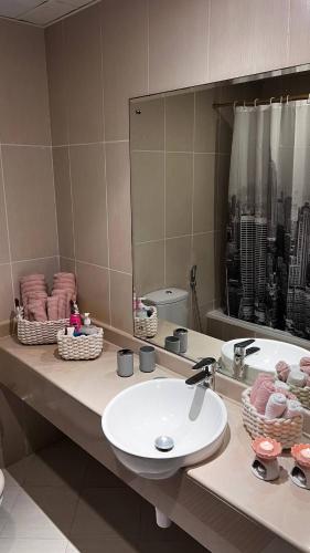 a bathroom counter with a sink and a mirror at Full sea view Studio high floor in Ras al Khaimah