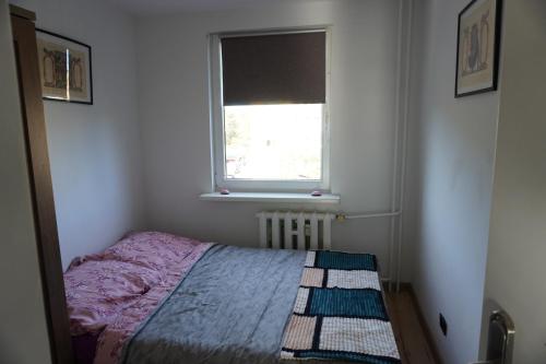a small bedroom with a bed and a window at SAS Militaria dla 2 par 2 pokoje 4 osoby in Borne Sulinowo