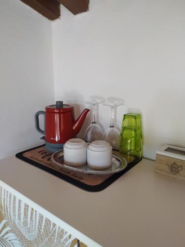 a shelf with a tea kettle and cups on it at La Terrazza di Emy, Arezzo - affitto turistico in Arezzo