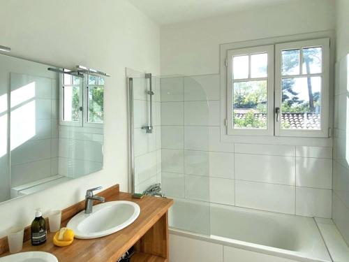 a bathroom with a sink and a shower and a tub at Villa spacieuse avec jardin pour 16 personnes - FR-1-736-31 in Lège-Cap-Ferret