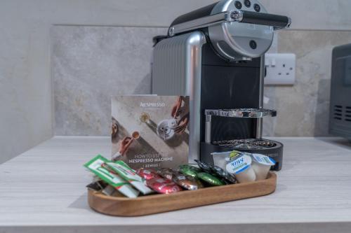 a kitchen counter with a mixer and a box of vegetables at Bankton Rooms & Lodges in Livingston