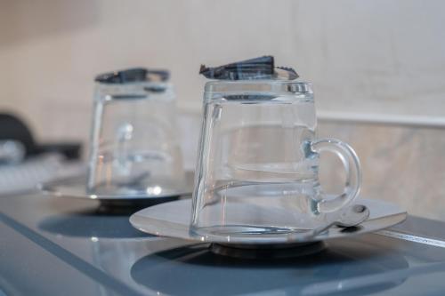 two glass cups sitting on top of a table at Bankton Rooms & Lodges in Livingston