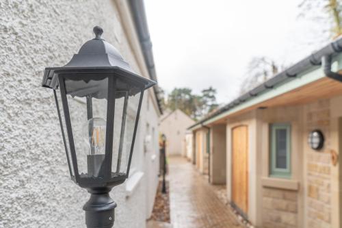 a black street light on the side of a building at Bankton Rooms & Lodges in Livingston