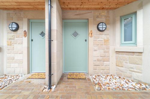a front door of a house with a bunch of shells at Bankton Rooms & Lodges in Livingston