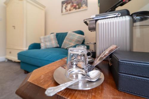 a table with a glass jar and spoons on it at Bankton Rooms & Lodges in Livingston