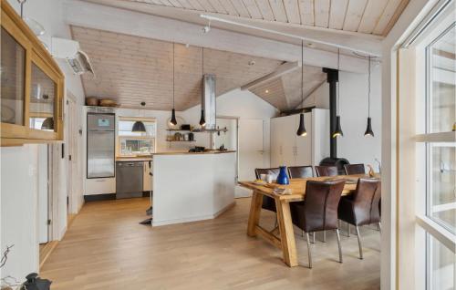 a kitchen and dining room with a table and chairs at Holiday Home Kuskevej Jerup Iv in Jerup