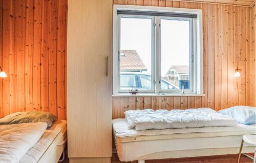 a bedroom with two beds and a window at Three-Bedroom Holiday Home In Ulfborg in Fjand Gårde