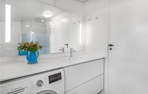 a white kitchen with a sink and a washing machine at Two-Bedroom Holiday Home In Nexo in Neksø
