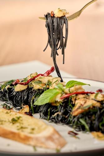 a plate of food on a fork with pasta at Aviyana Hua Hin in Cha Am