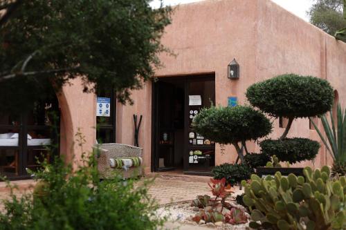 an entrance to a building with trees and plants at Paradis Nomade in Azrarag