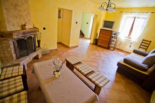 a living room with a couch and a fireplace at Holiday Home Stancija Becic in Mugeba