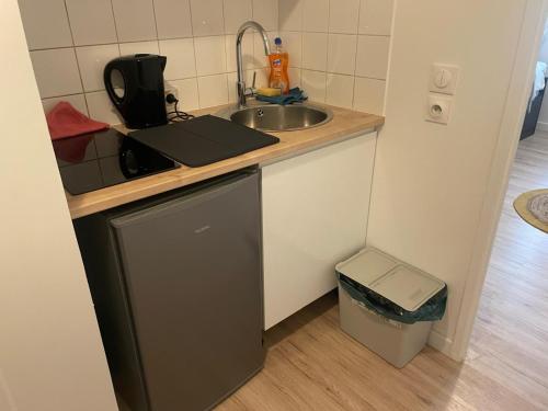 a small kitchen with a sink and a counter at Chambre privée proche stade de France et Paris dans appartement partagé in Pierrefitte-sur-Seine