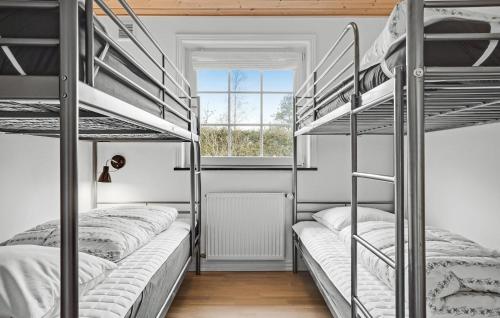 two bunk beds in a room with a window at Lovely Home In Ørsted With Wifi in Ørsted