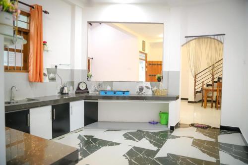 a kitchen with white walls and a marble floor at Kings Villa Mirissa in Mirissa