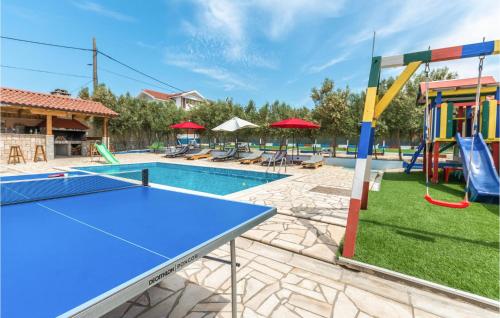a pool with a slide and a playground at Holiday Home Zadar 37 in Kakma