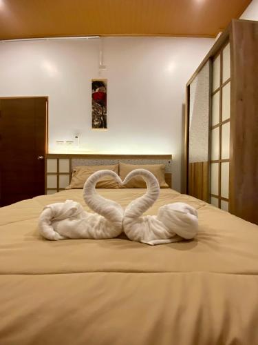 two swans making a heart on a bed at Taka Onzen in Ban Khao Ket