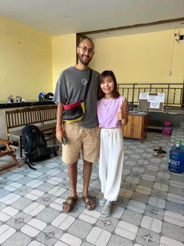 a man and a little girl posing for a picture at Vang vieng guesthouse in Vang Vieng