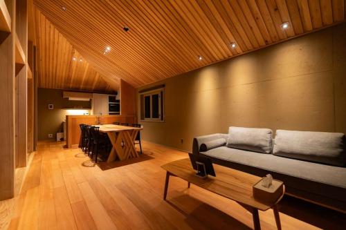 a living room with a couch and a table at Shiraho Villa Square Court in Ishigaki Island