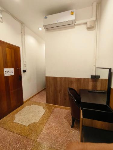 an empty room with a desk and a door at Penthouse Lamoon in Bangkok