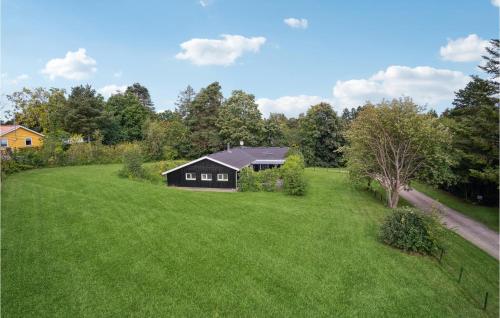 an aerial view of a large yard with a black house at Pet Friendly Home In Knebel With Sauna in Skødshoved Strand