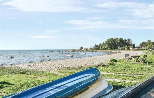 a blue raft sitting on a rail next to a beach at Gorgeous Home In Kolind With Wifi in Kolind