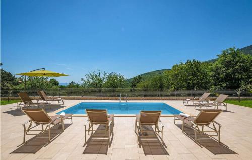 a group of chairs and a swimming pool at Villa Terra in Mošćenička Draga
