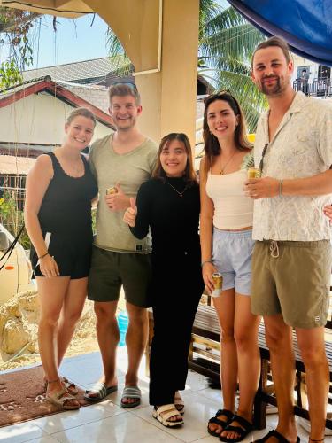 a group of people posing for a picture at Vang vieng guesthouse in Vang Vieng